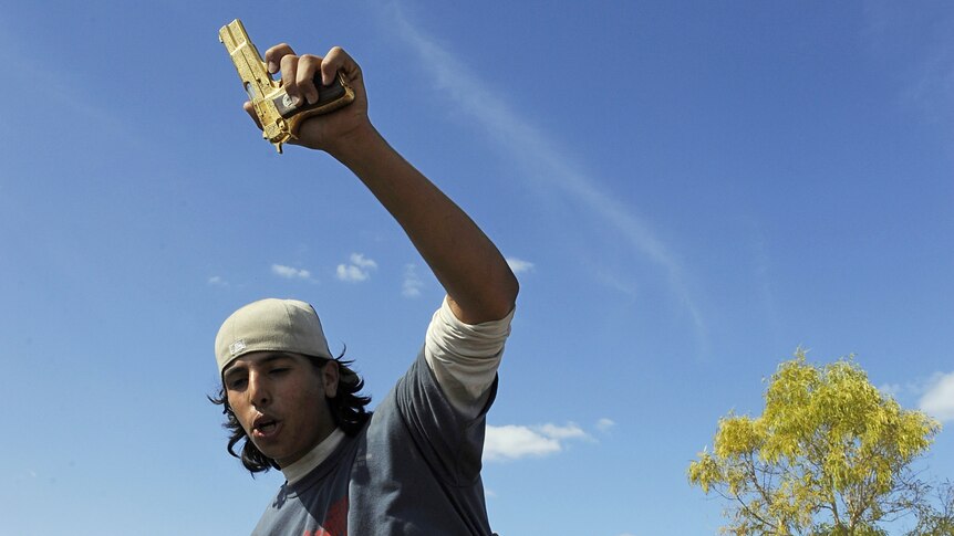 Libyan man carries golden gun