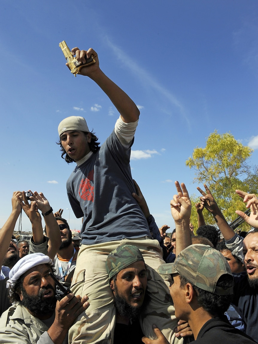 Libyan man carries golden gun