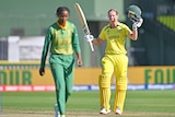 Meg Lanning raises her bat after scoring a century against South Africa in the women's cricket world cup