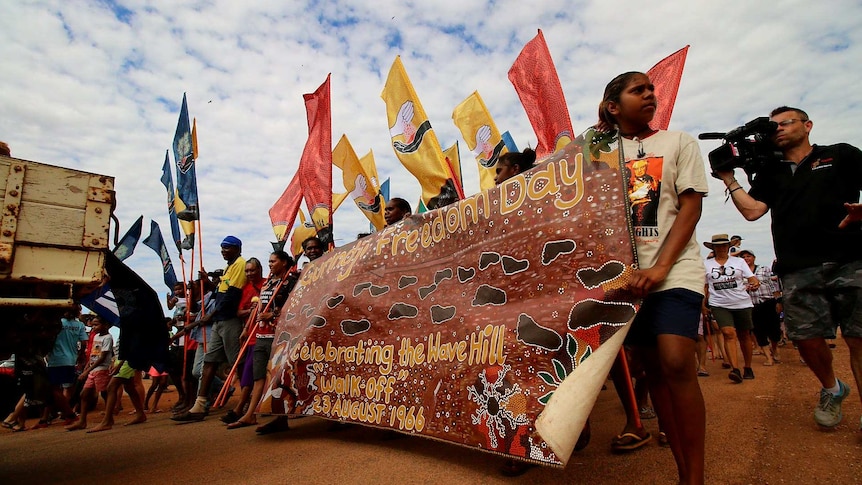 Marchers carrying a banner saying 'Gurindji Freedom Day'.