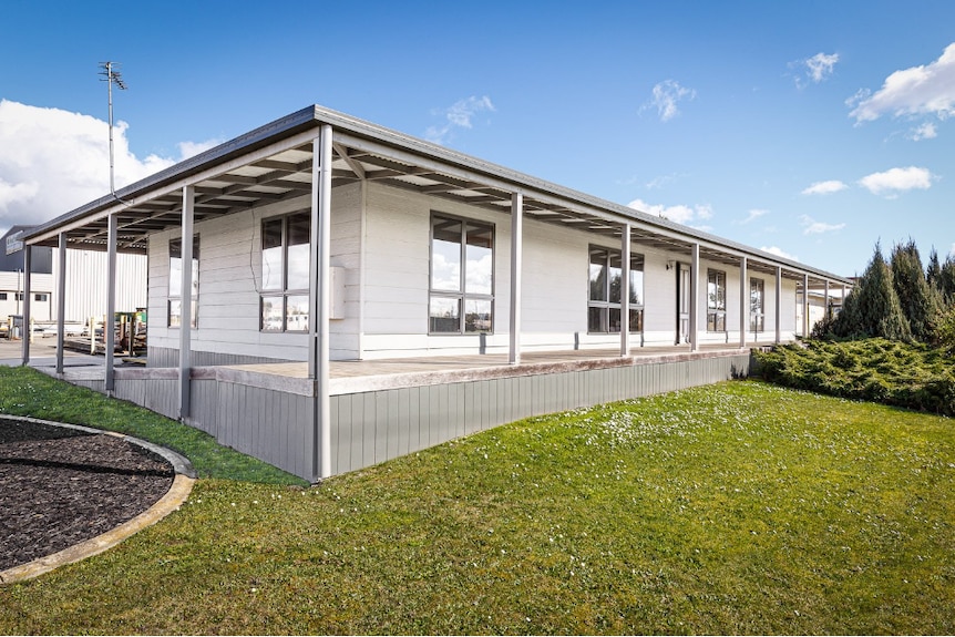 A weatherboard home with a verandah. 