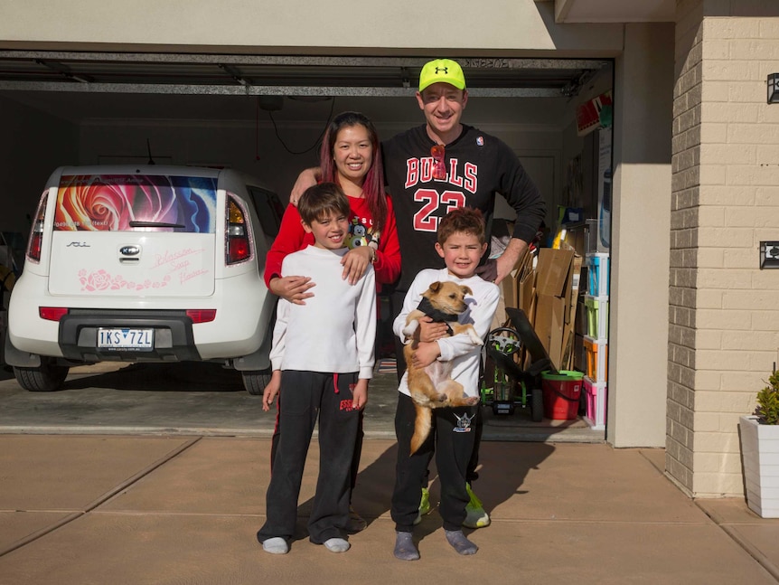 Annie Radulovich, pictured with her husband Rob and sons Darius and Deon, standing at the front of their home