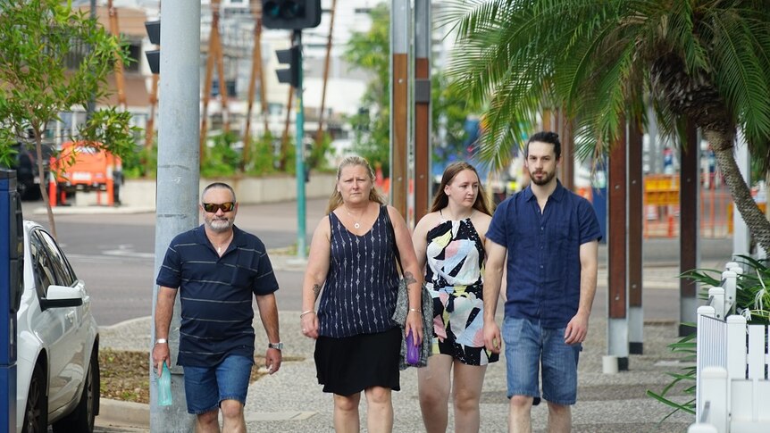 The four family members walk outside