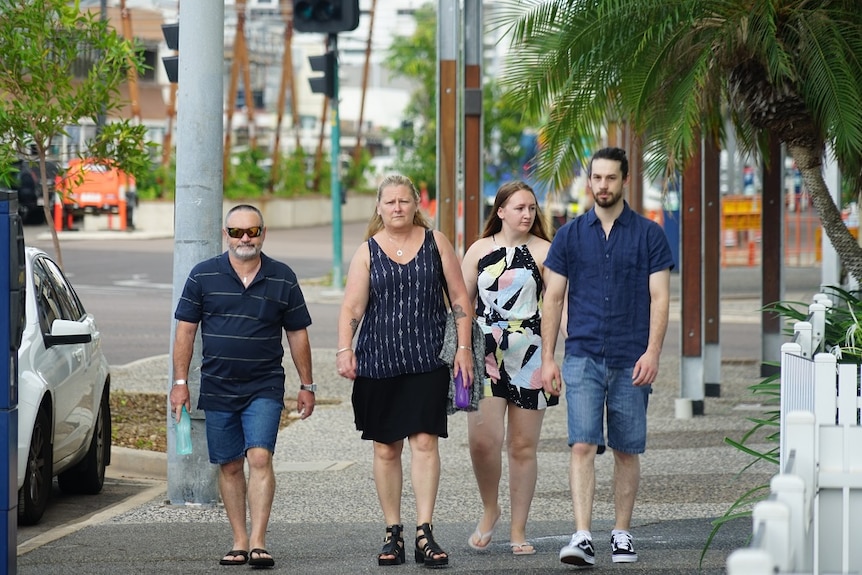 The four family members walk outside