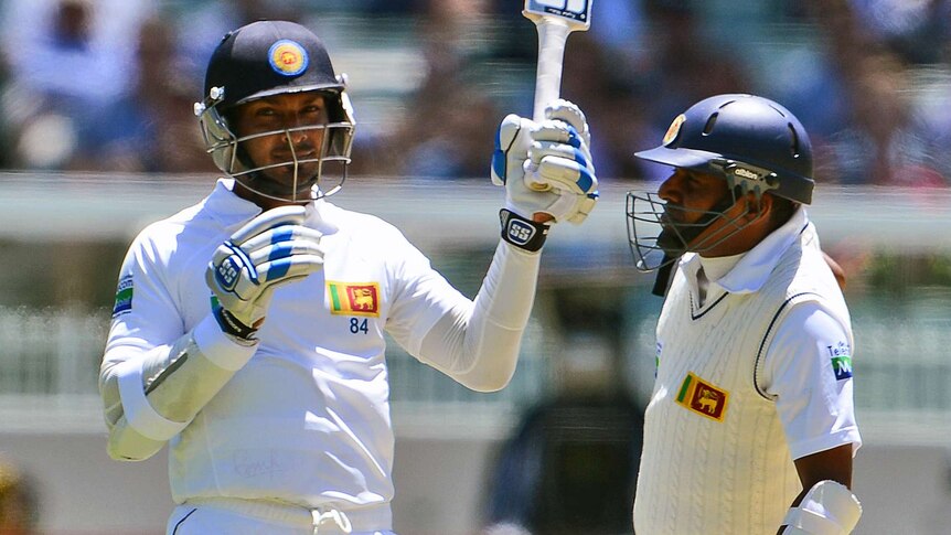 Huge milestone ... Sri Lanka's Kumar Sangakkara (L) acknowledges the crowd after passing 10,000 Test runs.