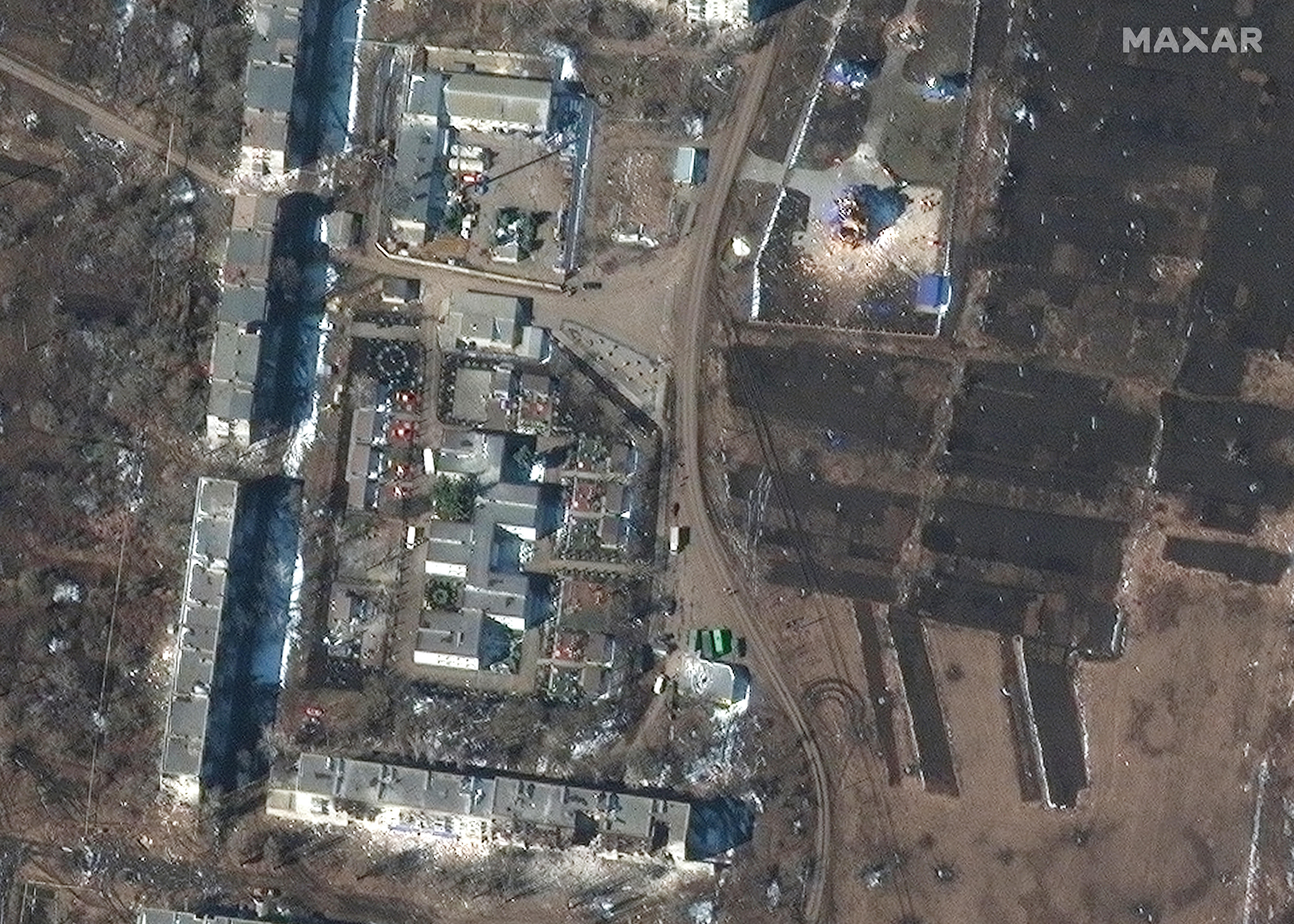 Satellite image of destroyed apartment complex and church.