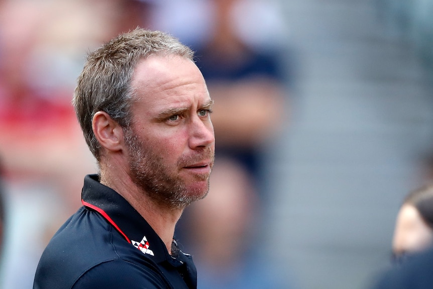 Essendon coach Ben Rutten looks dejected during a game against Geelong