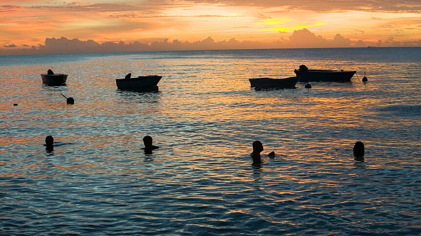 Tuvaluans sit near the sea. Tuvalu will b the first country to disappear as a result of climate change.