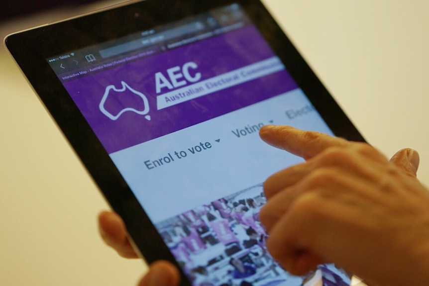 Person holding a computer tablet on the Australian Election Commission e-Voting website in July 2016.