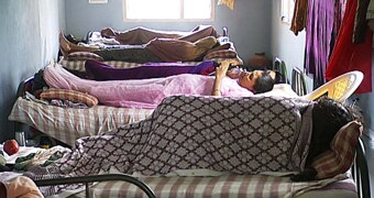 Women in India lie on beds at clinic custom
