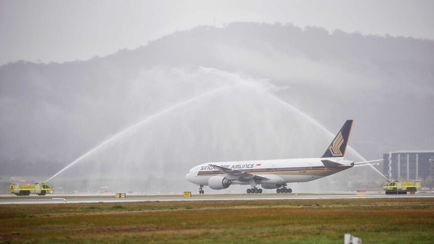 The first Singapore Airlines flight is greeted with a water cannon salute.