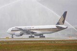 The first Singapore Airlines flight is greeted with a water cannon salute.