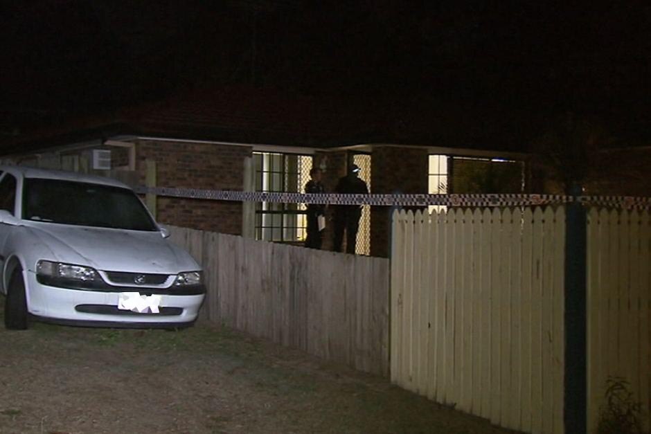 Police stand outside Forest Lake house where mum and son stabbed.