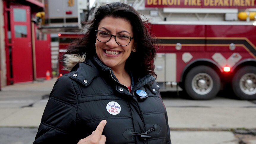 Democratic US congressional candidate Rashida Tlaib points to her 'I voted' sticker.