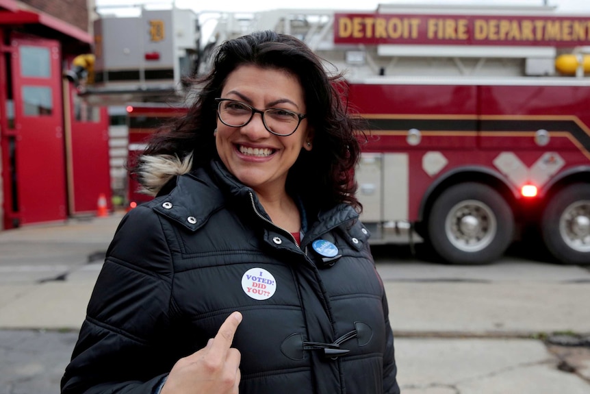 Democratic US congressional candidate Rashida Tlaib points to her 'I voted' sticker.