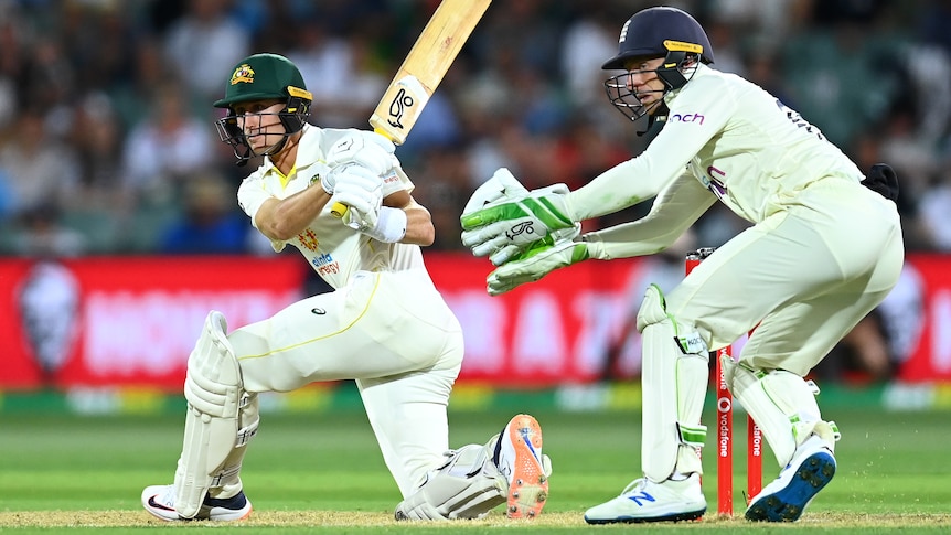 Marnus Labuschagne sweeps on one knee as Jos Buttler watches on