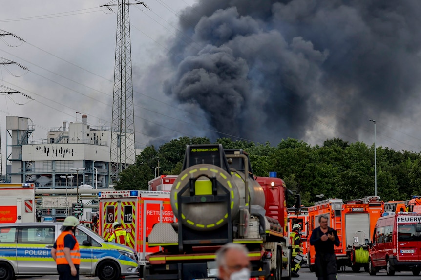 Smoke billows into the air as fire services surround the blaze in Germany