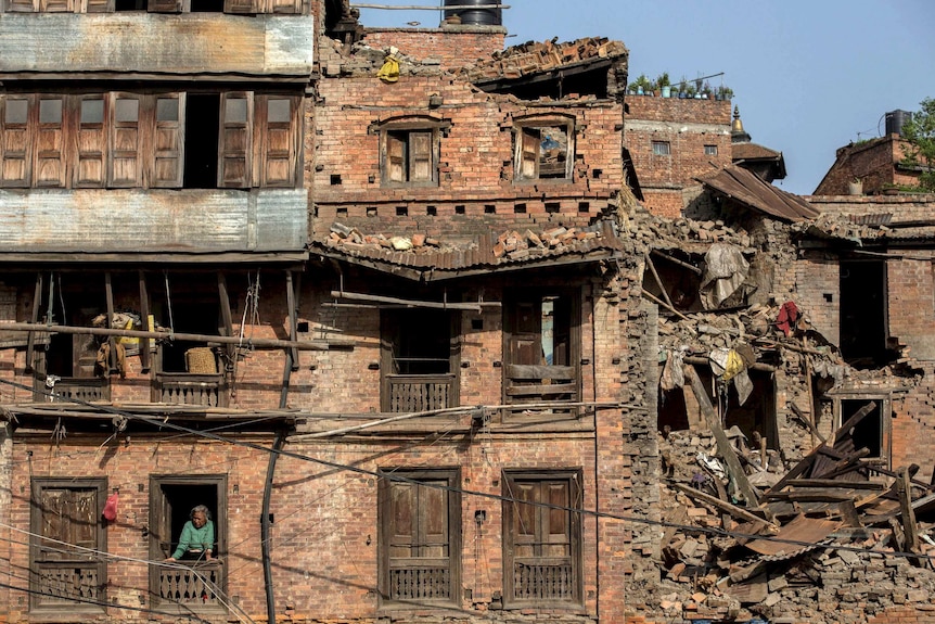 A woman looks out her window in Nepal after the earthquake on May 1, 2015