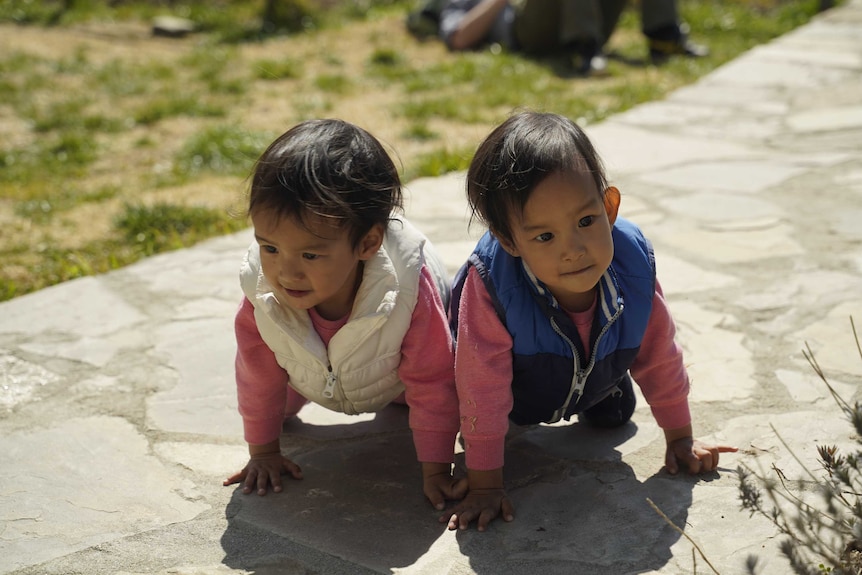 On the move: separated conjoined twins Nima (left) and Dawa home in Bhutan