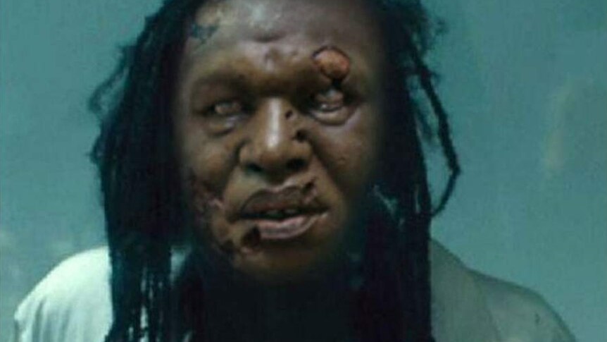 An image of a black man who appears to be a zombie against a green screen. It is a fake image adapted from the film World War Z.