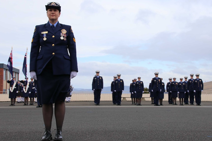A female police officer leads the graduation parade at the Tasmanian Police Academy.
