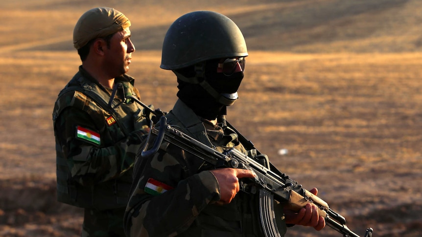 Iraqi Kurdish Peshmerga fighters take position on the front line in Khazer