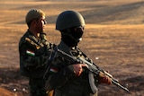 Iraqi Kurdish Peshmerga fighters take position on the front line in Khazer
