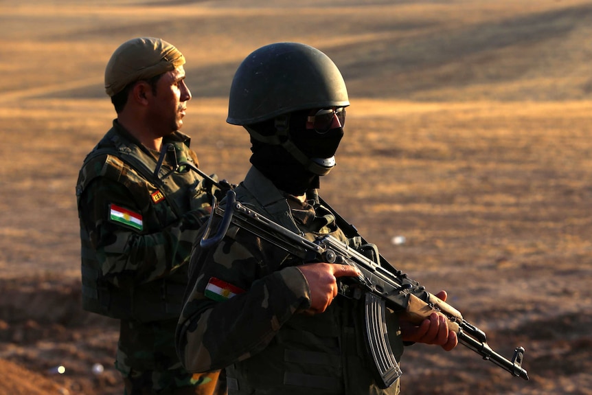 Iraqi Kurdish Peshmerga fighters take position on the front line in Khazer