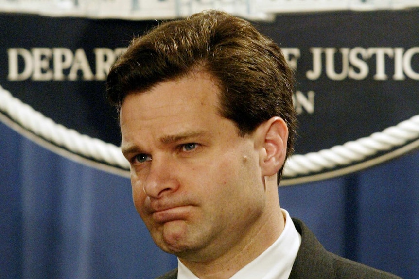 A headshot of Christopher Wray during a press conference.