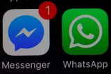 WhatsApp and Facebook messenger icons on an iPhone