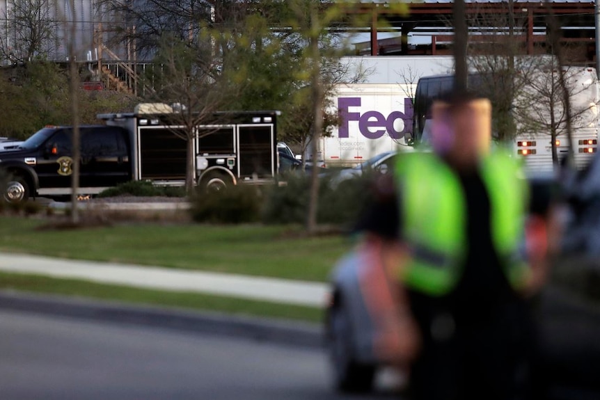 Emergency vehicles sit in front of a FedEx distribution centre where a package exploded.