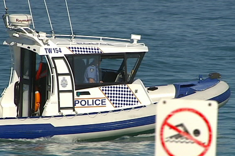 Police boat on water with no swim sign
