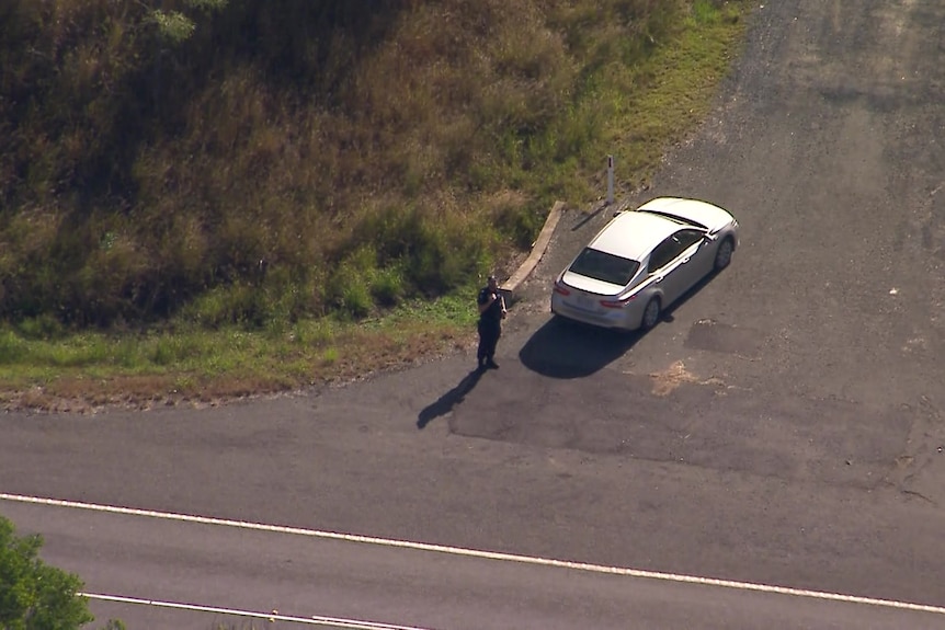 aerial view of a police car and officer at a roadside