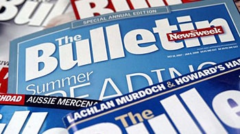 Numerous issues of The Bulletin magazine scattered on a table.