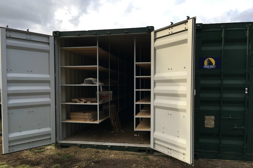 An empty shipping container with doors open