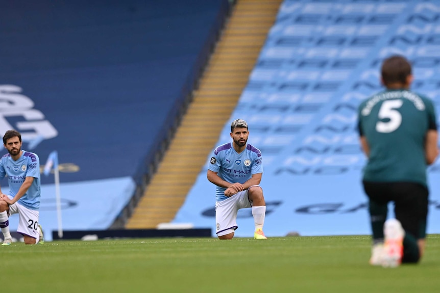 Players kneel ahead of the Manchester City - Burnley game