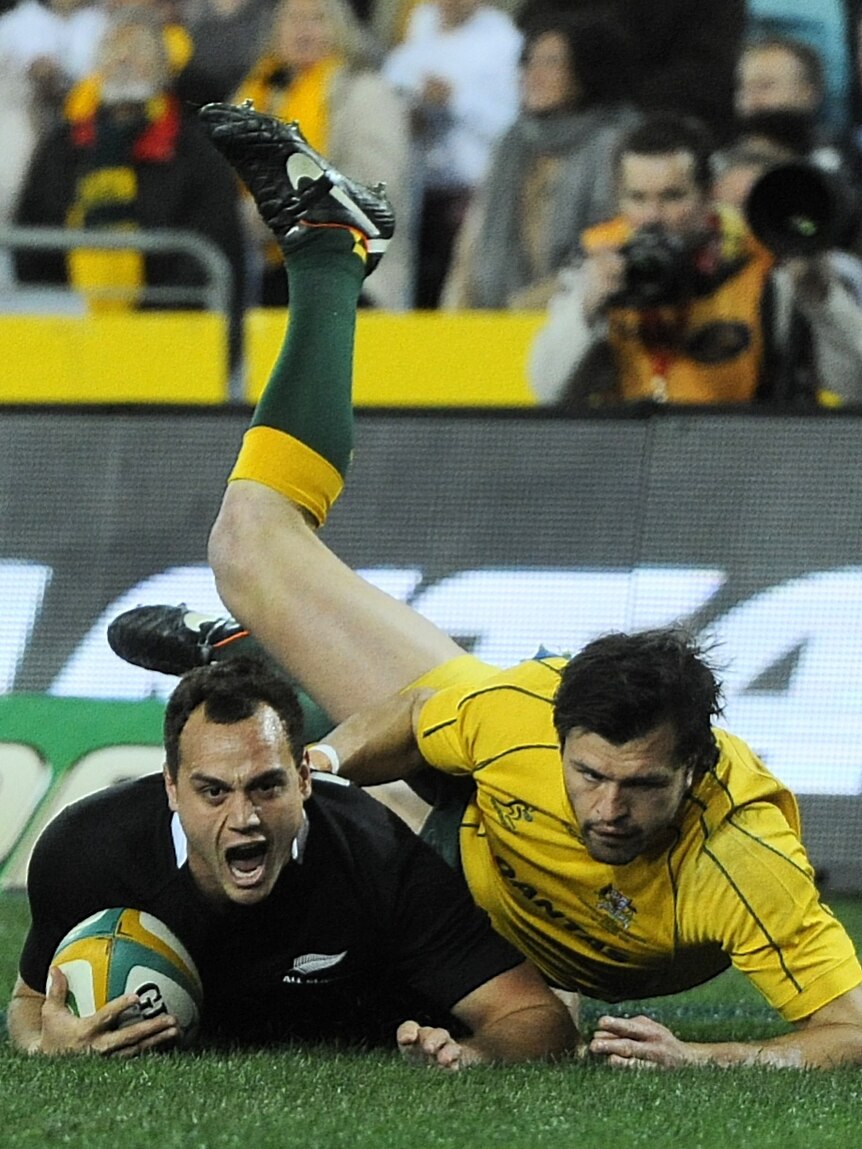 Early advantage ... Israel Dagg beats the defence of Adam Ashley-Cooper to score for the All Blacks