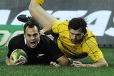 Early advantage ... Israel Dagg beats the defence of Adam Ashley-Cooper to score for the All Blacks