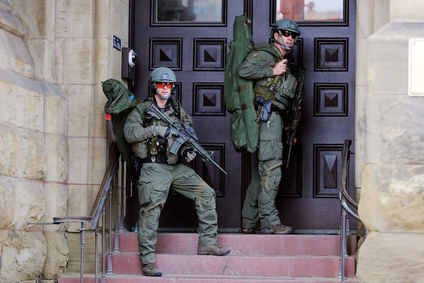 Canada shooting. Armed police outside Canada's parliament building after a gunman entered the building and fired shots