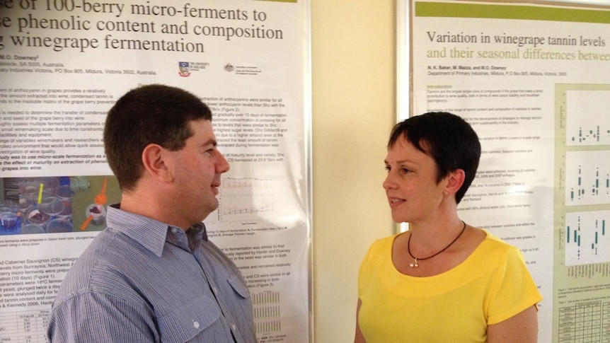 Vince DeMaria and Minister Jaala Pulford stand in front of government style posters.