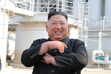 Kim Jong-un laughing while crossing his arms