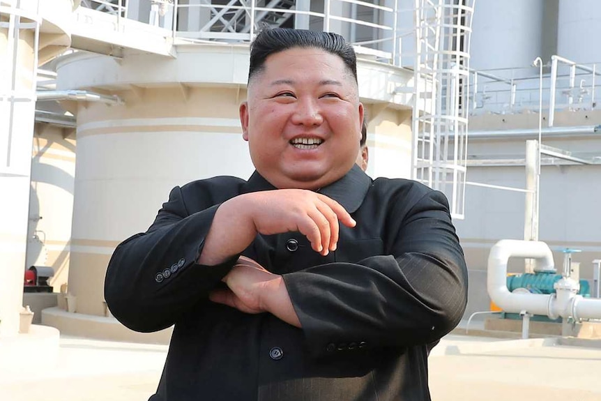 Kim Jong-un laughing while crossing his arms