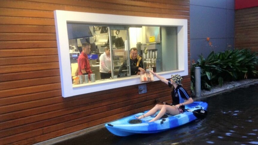 Girl paddles up restaurant drive-thru during Port Lincoln flooding