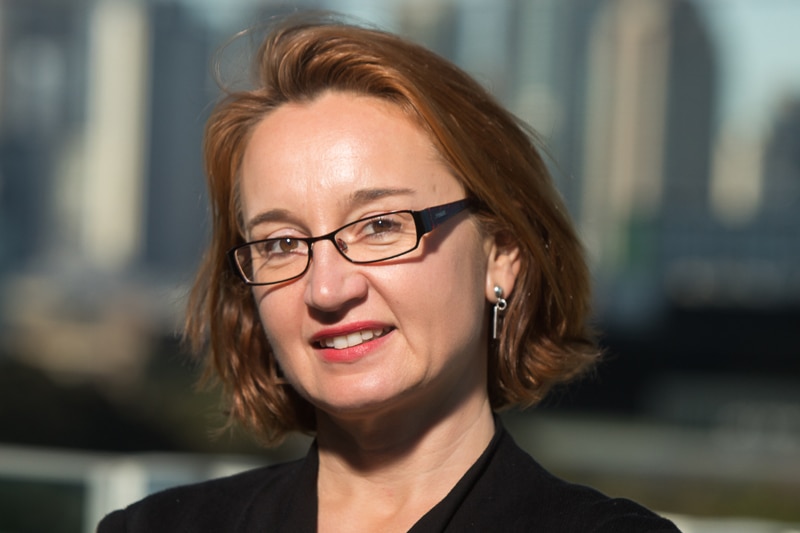 Headshot of Associate Professor Jacqui Webster in front of a city skyline