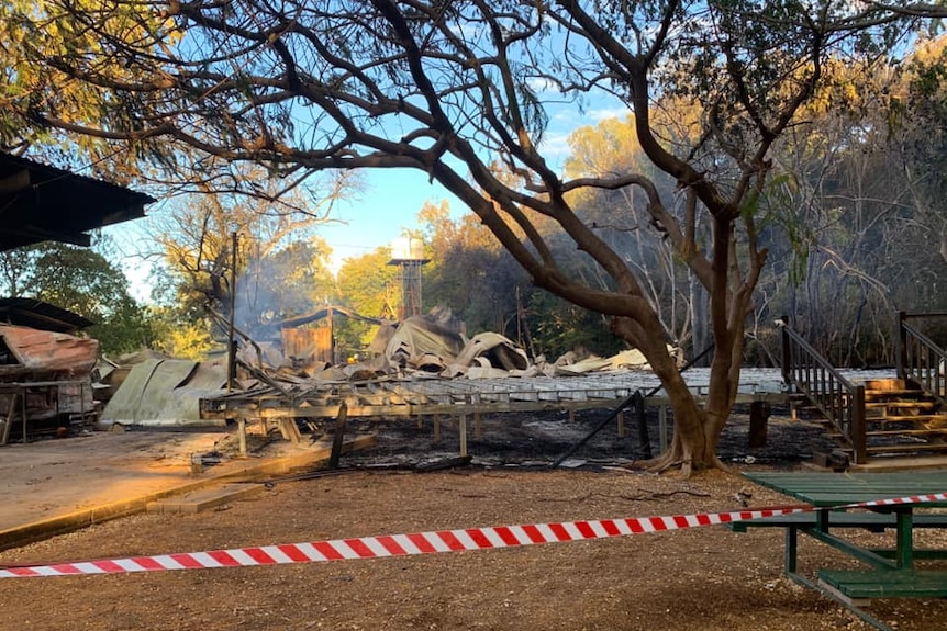 A burnt-out area surrounded by trees.