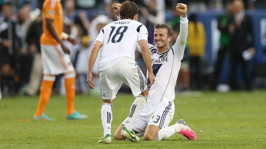 US champions ... David Beckham celebrates with Galaxy team-mate Mike Magee.