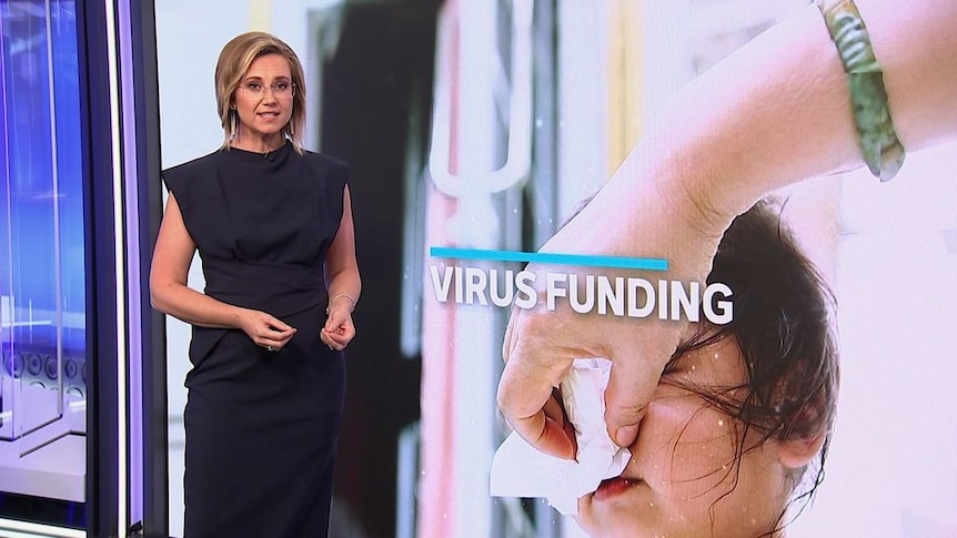A newsreader speaks next to a graphic of a child having their nose blown with the words 'Virus Funding'.