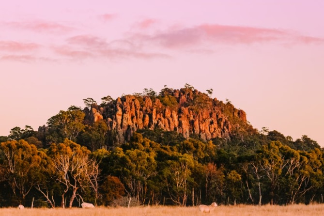 Hanging Rock in Victoria with the sun turning the rock orangey pink