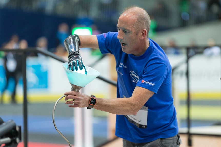 Team-Imperial competitor screws in a lightbulb with his robotic arm at Cybathlon