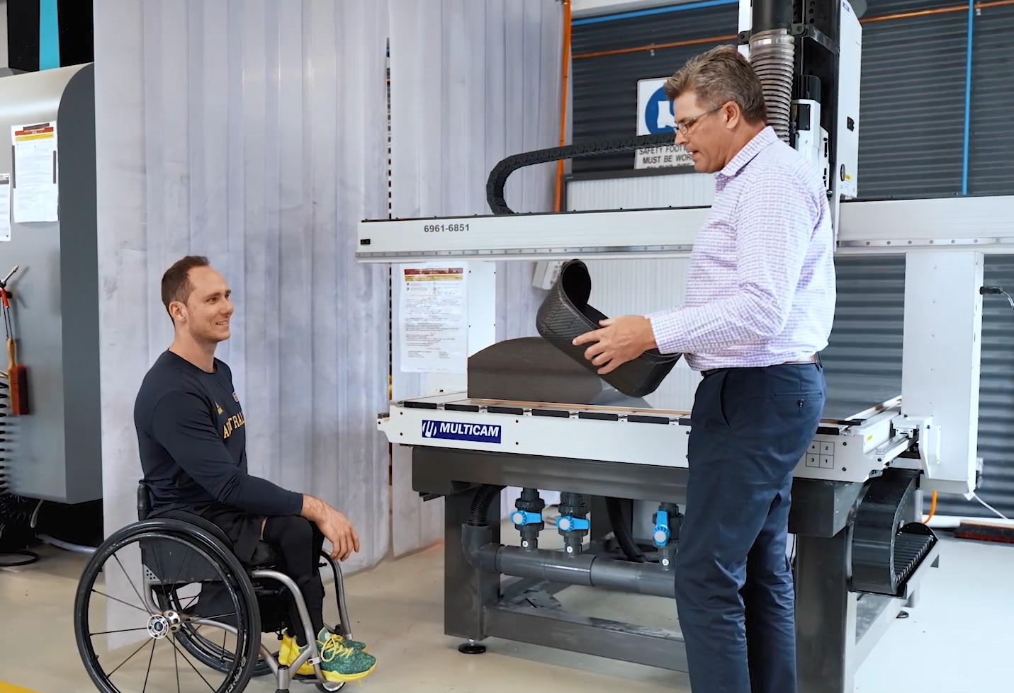 Tom O'Neill Thorne and Matt Crawford look at a seat while in a lab at the AIS.